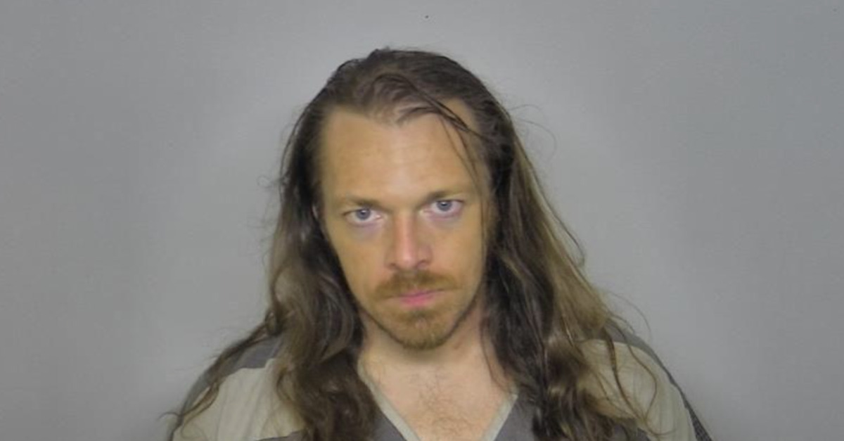 Derek Dillman appears in a mugshot