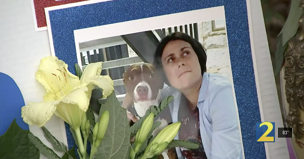 Katie Janness and Bowie the pitbull are remembered in a picture placed at their vigil