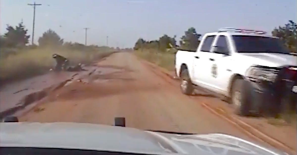 A freeze frame from a pursuing patrolman's dashboard camera video shows the seconds after suspect Lucas Strider crashed an allegedly stolen ATV.