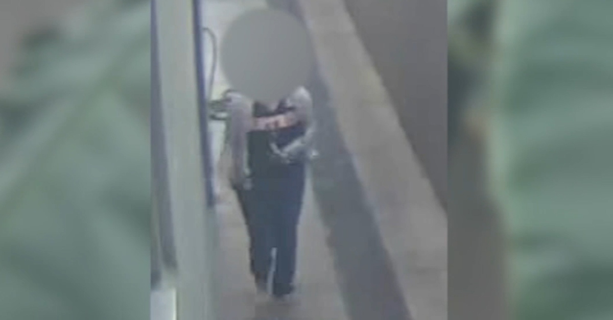 Surveillance footage of woman identified as Tiffany Peteet. Her face is blurred out.