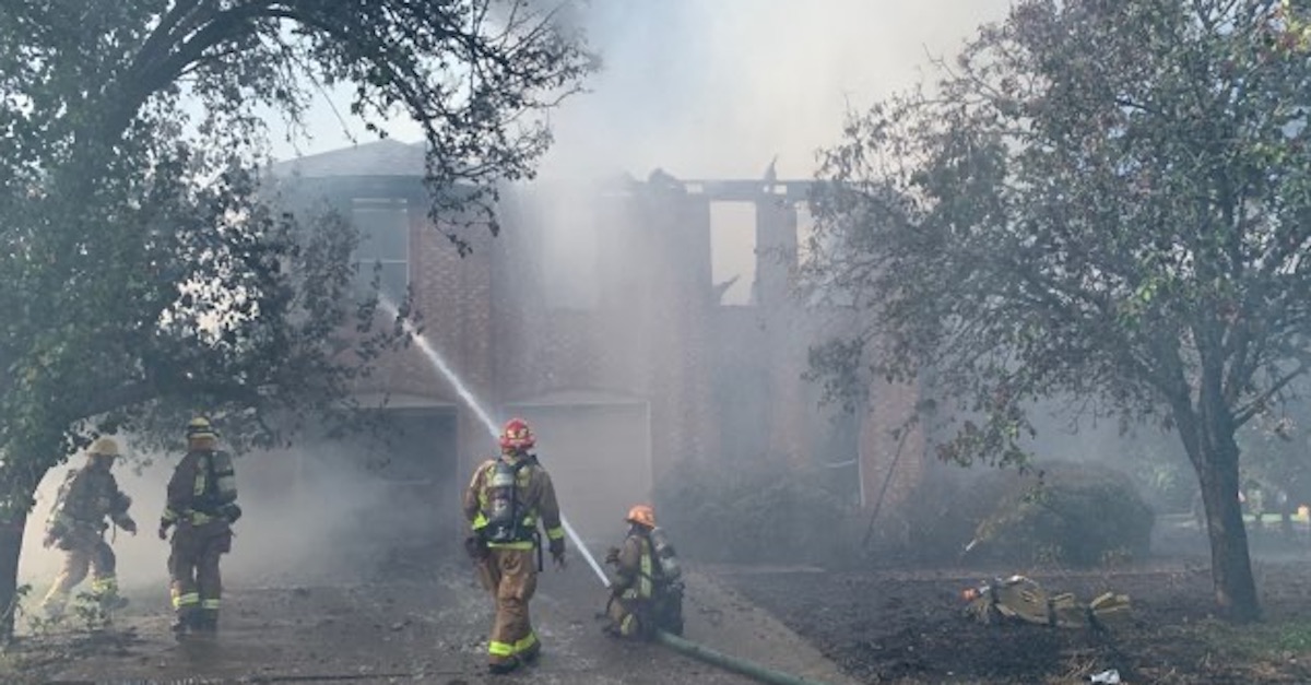 Austin, TX Firefighters extinguish a house fire