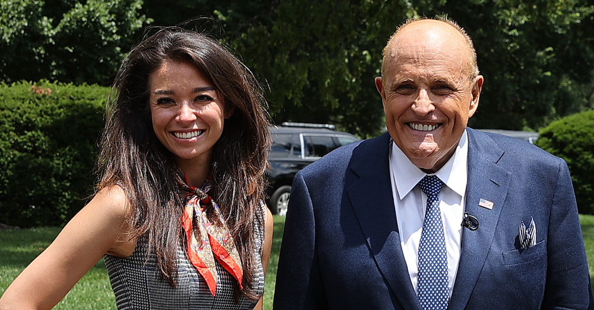 One America News Network's Chanel Rion (L) poses for photographs with President Donald Trump's lawyer and former New York City Mayor Rudy Giuliani following an interview outside the White House West Wing July 1, 2020. (Photo by Chip Somodevilla/Getty Images.)