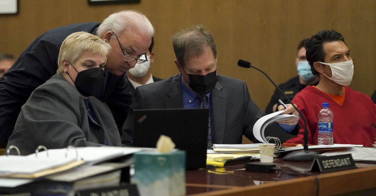 Scott Peterson, right, sits as attorneys Shelley Sandusky, from left, meets with Pat Harris and Cliff Gardner during a hearing at the San Mateo County Superior Court in Redwood City, Calif., Friday, Feb. 25, 2022. (Image via Jeff Chiu/The Associated Press/Pool.)