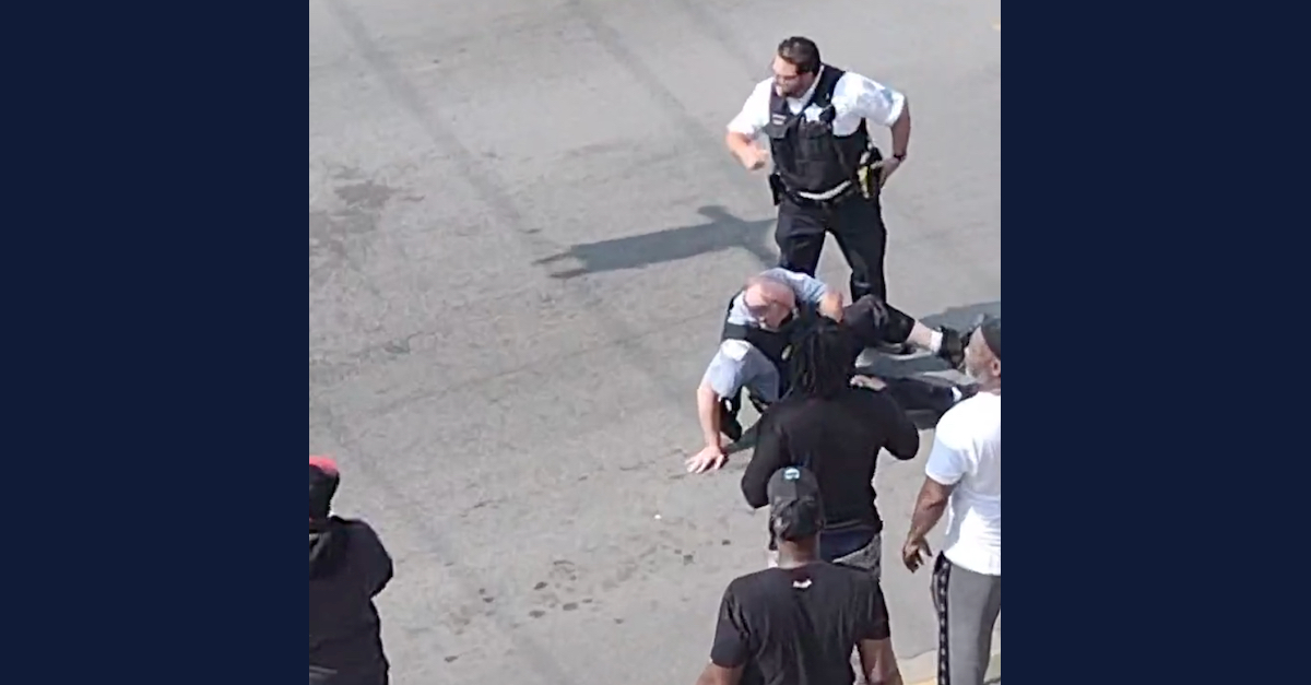 An officer laying on the street after being struck by his own car in Chicago