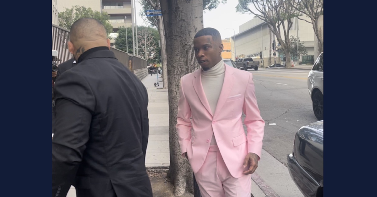 Tory Lanez in a powder pink suit walking into the criminal courthouse in downtown Los Angeles