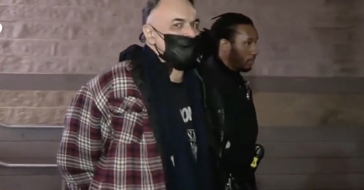 Accused MoMA stabber Gary Cabana being escorted by police. (YouTube screen shot)