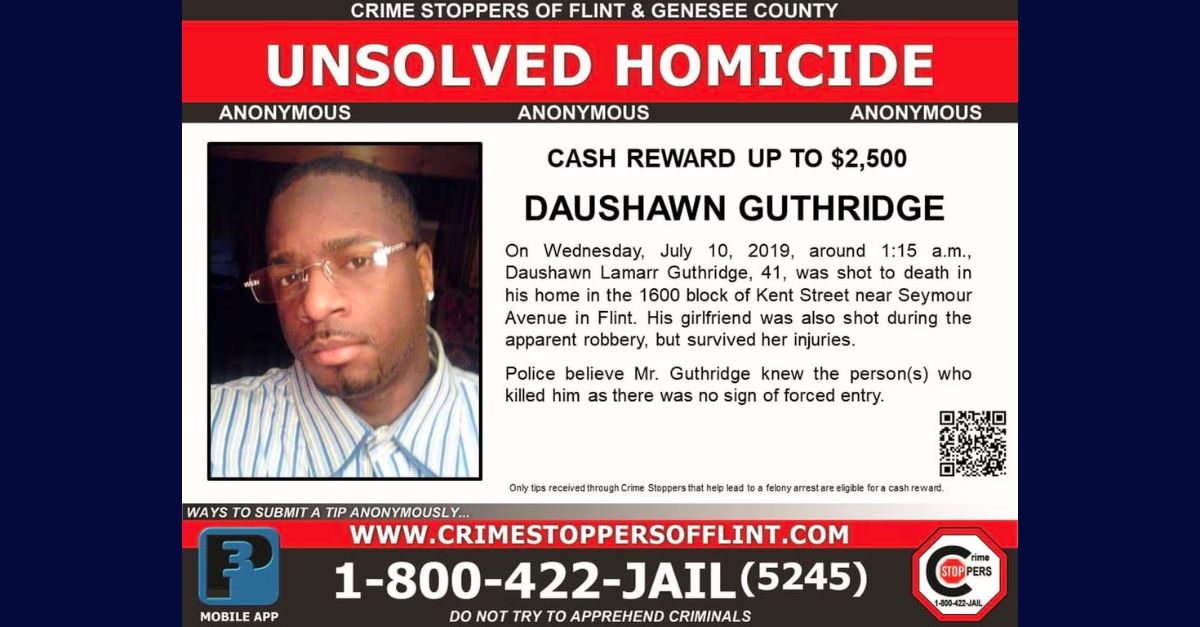 A Crimestoppers poster offers a reward for information about the murder of Daushawn Guthridge