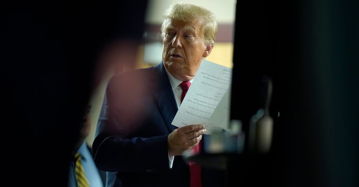 Former President Donald Trump holds papers moments before stepping on stage to address an audience at a campaign event, Monday, Oct. 9, 2023, in Wolfeboro, N.H. (AP Photo/Steven Senne)