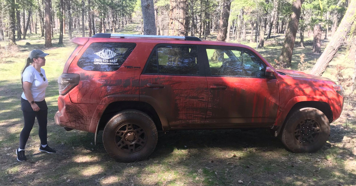 Analiese Golde could be driving the 2015 burnt orange Toyota 4Runner with the Oregon license plate 501HSB, Portland police said on Jan. 30, 2024. This is her standing by the vehicle, they said. (image: Portland Police Bureau)