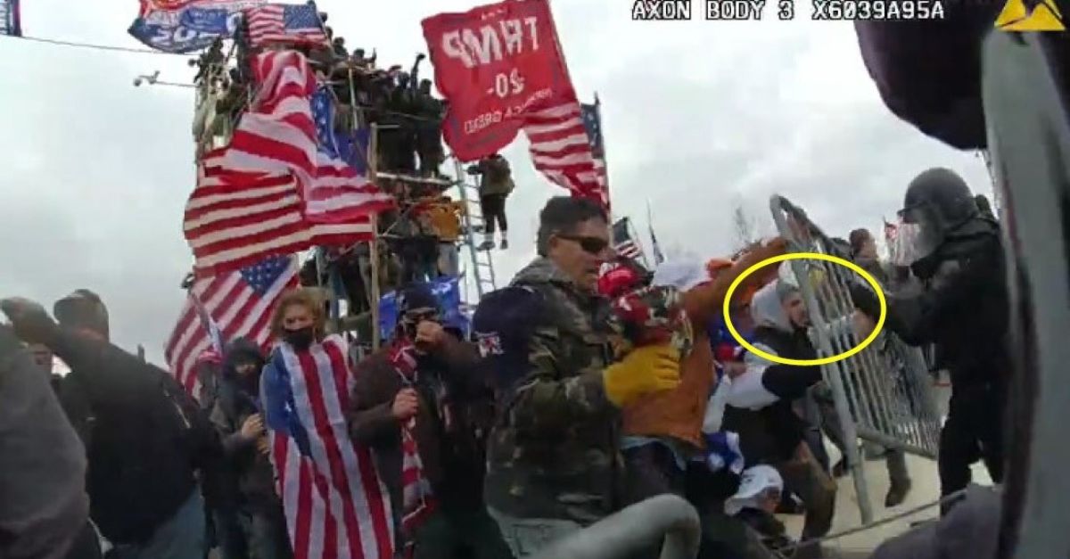 Department of Justice exhibit allegedly show Matthew Valentin, circled in yellow, pushing through a bike rack barrier as police defend the U.S. Capitol on Jan. 6, 2021.