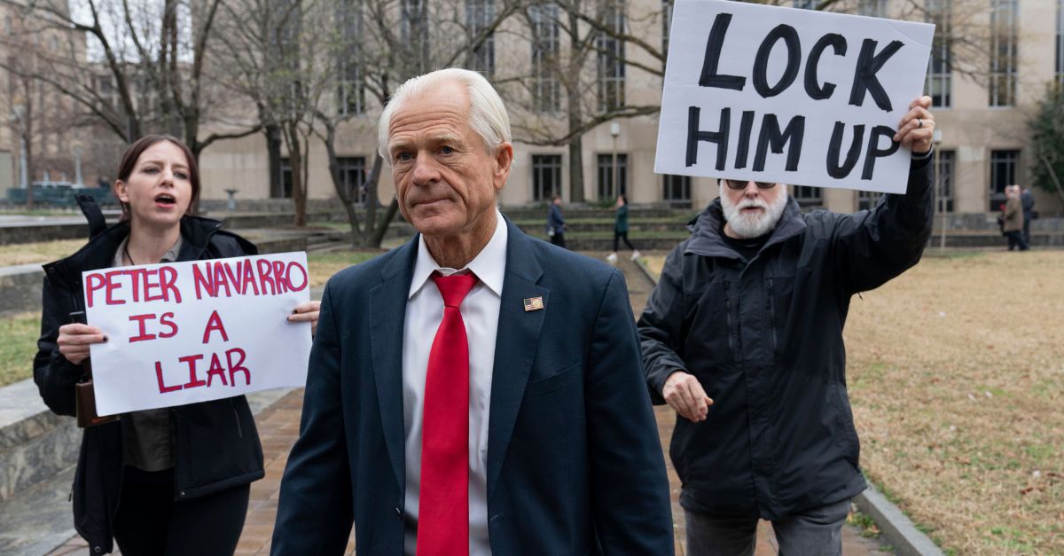 Former Trump White House official Peter Navarro followed by demonstrators leaves the U.S. Federal Courthouse in Washington, Thursday, Jan. 25, 2024. Navarro, who was convicted of contempt of Congress for refusing to cooperate with a congressional investigation into the Jan. 6, 2021, attack on the U.S. Capitol, was sentenced on Thursday to four months behind bars. (AP Photo/Jose Luis Magana)