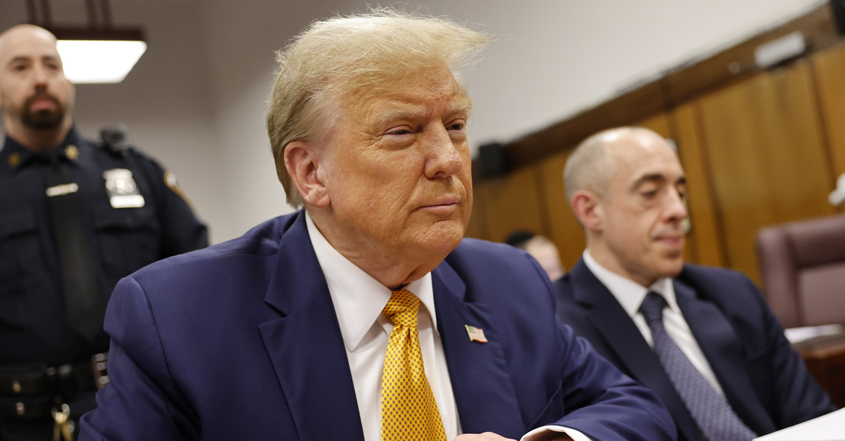 Former President Donald Trump sits and crosses his hands as he appears at Manhattan criminal court before his trial in New York, Tuesday, May 14, 2024.