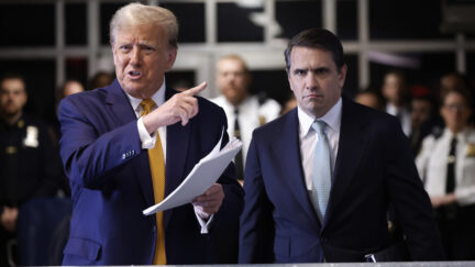 Former President Donald Trump speaks with members of the media and points at attorney Todd Blanche listens before the start of his trial at Manhattan criminal in New York, Tuesday, May 14, 2024.