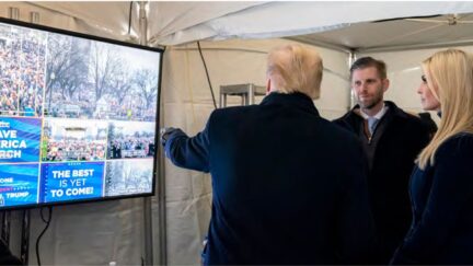 In this image released in the final report by the House select committee investigating the Jan. 6 attack on the U.S. Capitol, on Thursday, Dec. 22, 2022, President Donald Trump looks at video monitors showing the crowd gathered on the Ellipse on the morning of Jan. 6, 2021, before he spoke. At rights is Ivanka Trump and second from right is Eric Trump. (House Select Committee via AP)