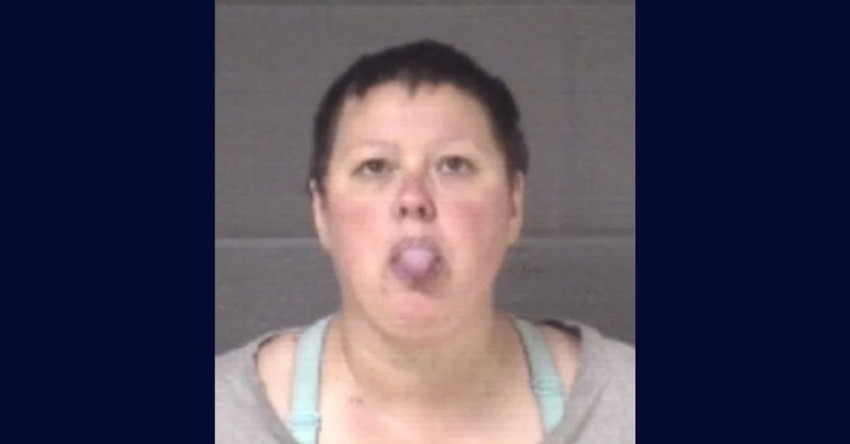 Danya Kathryn Dewey appears in a booking photo with her tongue sticking out.