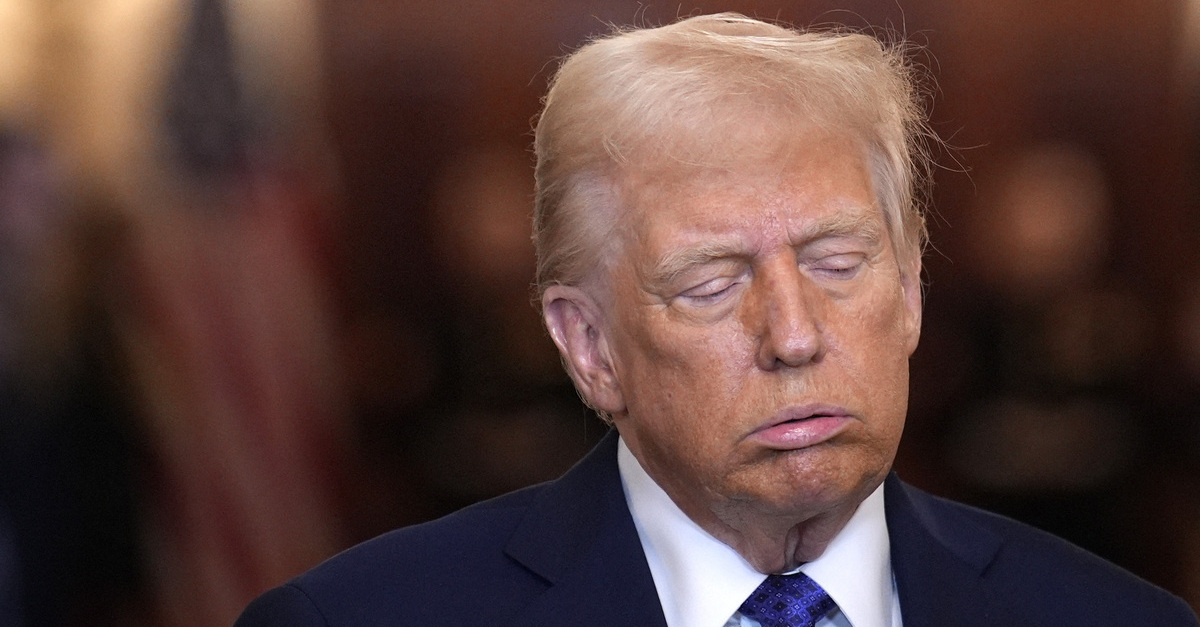 Donald Trump sighs during a press conference.