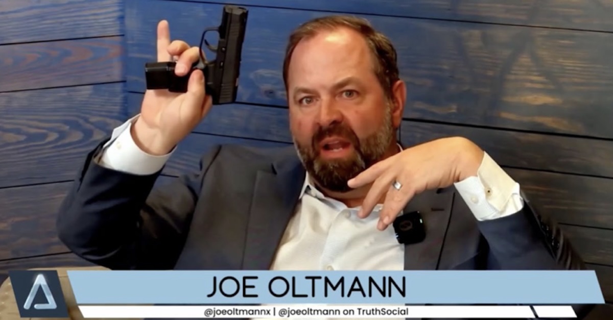 Joe Oltmann holding a gun 