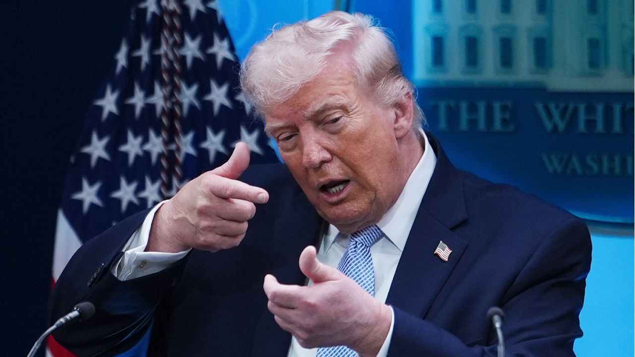 Donald Trump makes a gun gesture.